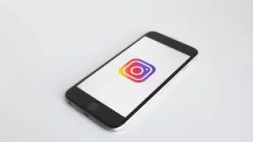 Smartphone displaying Instagram logo on screen.