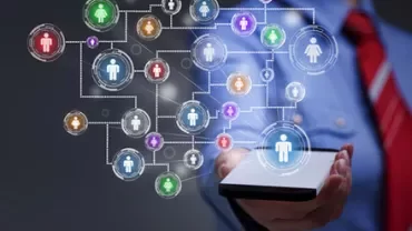 Person holding a smartphone with floating network icons showing social connections.