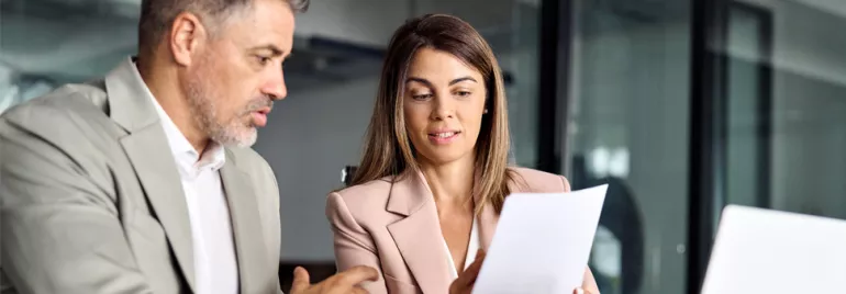 man and woman looking at a document